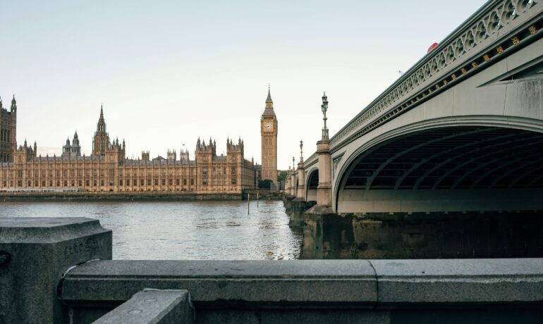 View of Big Ben and Westminster Bridge at dusk in London, England, UK.